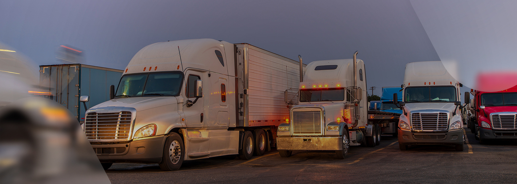 Commercial semi-trucks with trailers parked