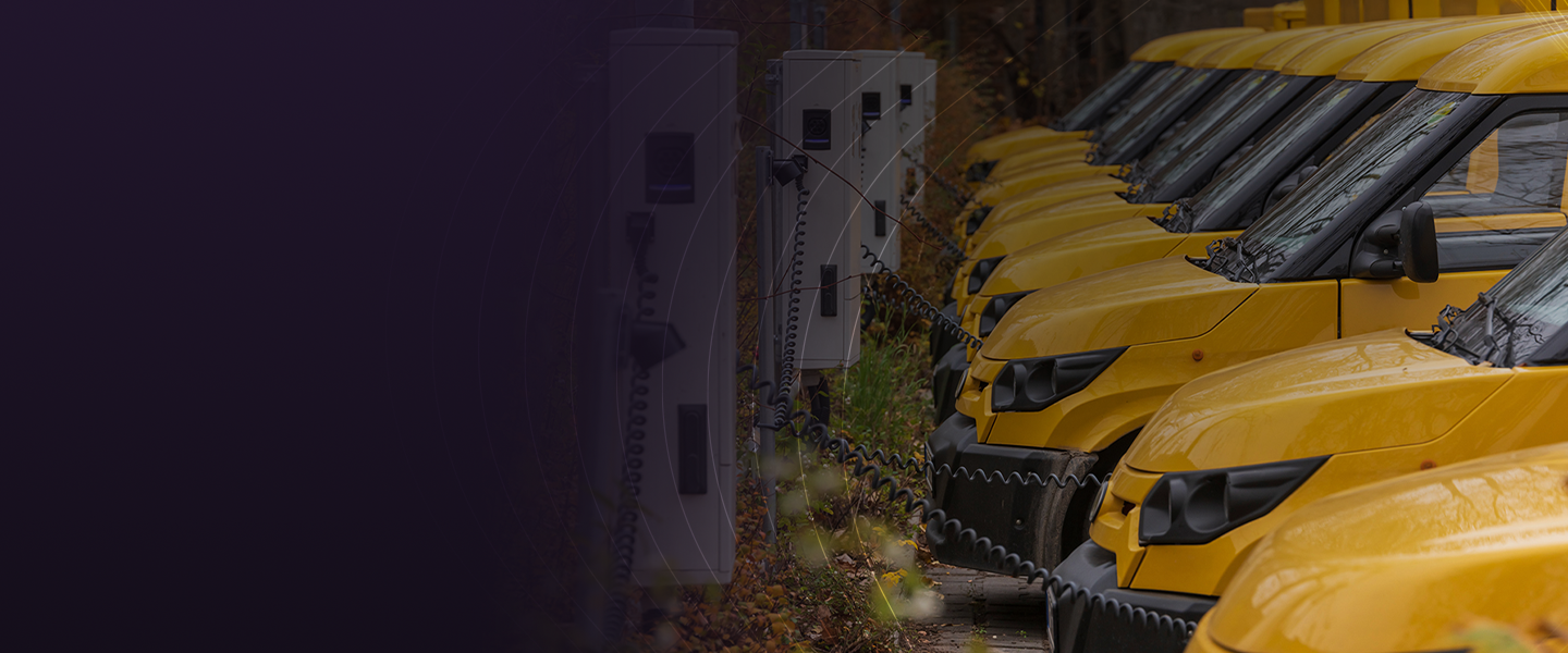 Yellow electric vehicle charging at a charging station